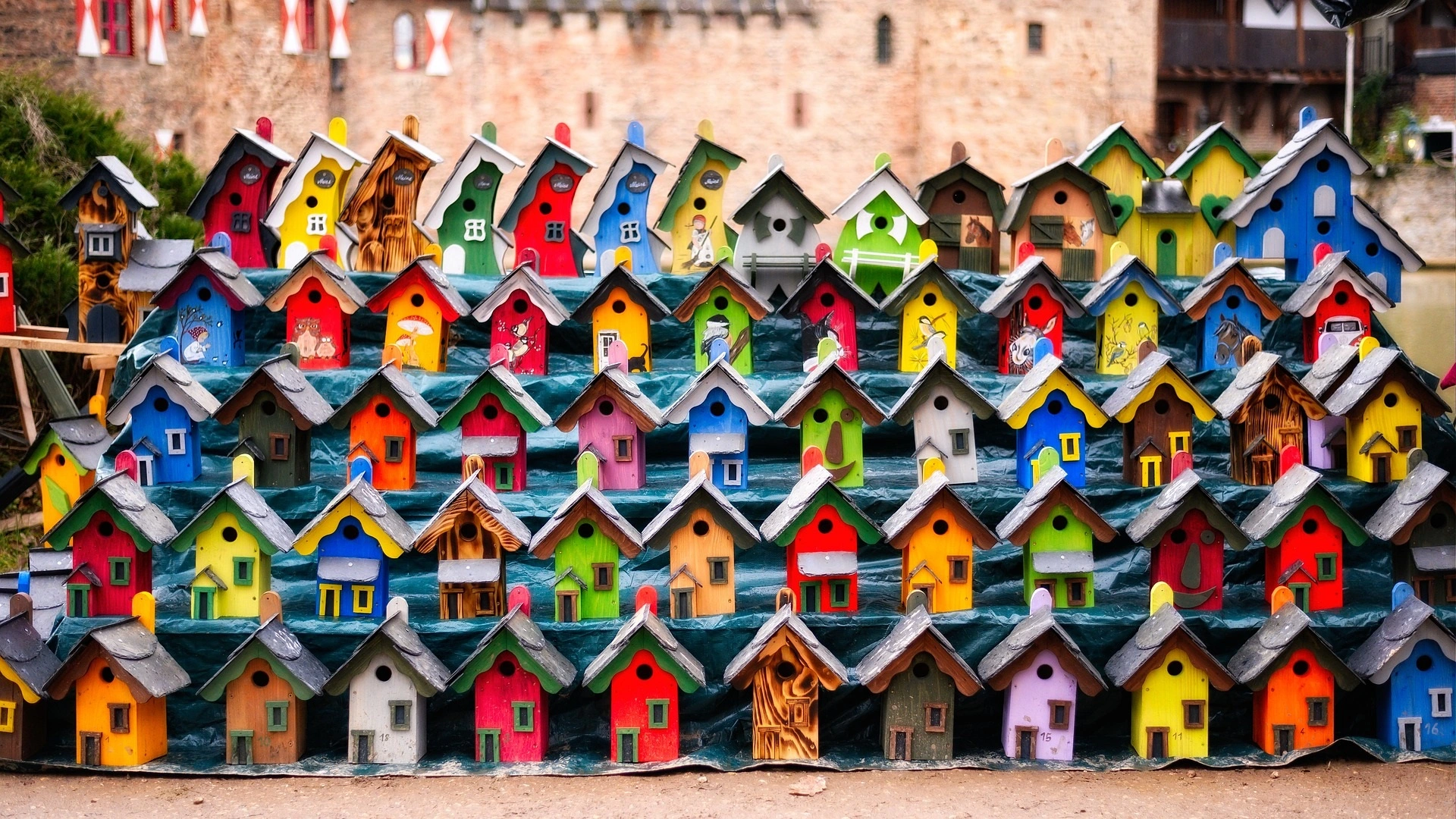 Rows and rows of playful brightly decorated wooden bird houses